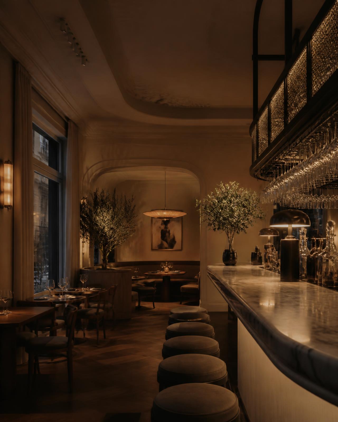 Warmly lit boutique restaurant interior with a marble bar and soft amber lighting
